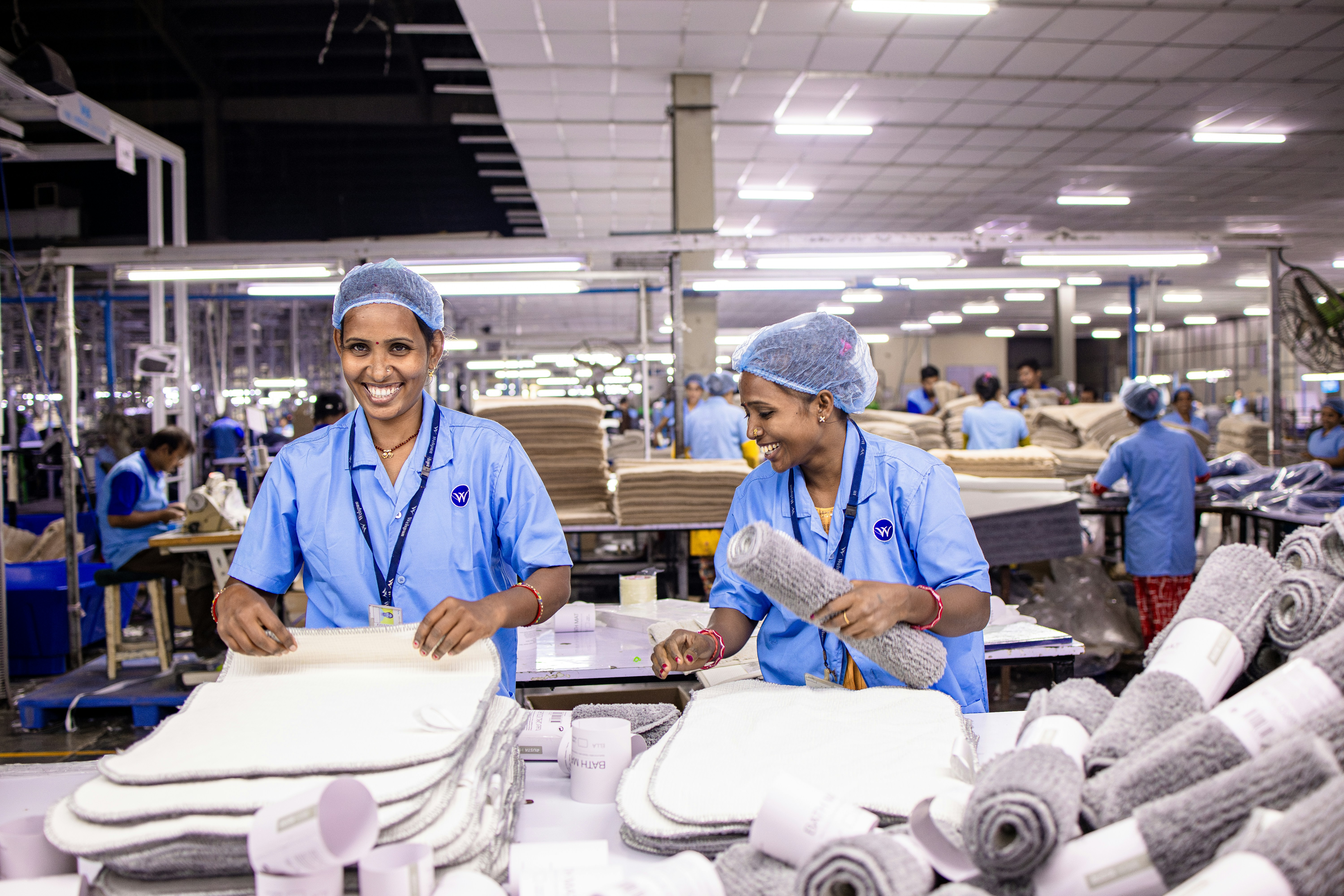Factory workers preparing textile products inside a production facility